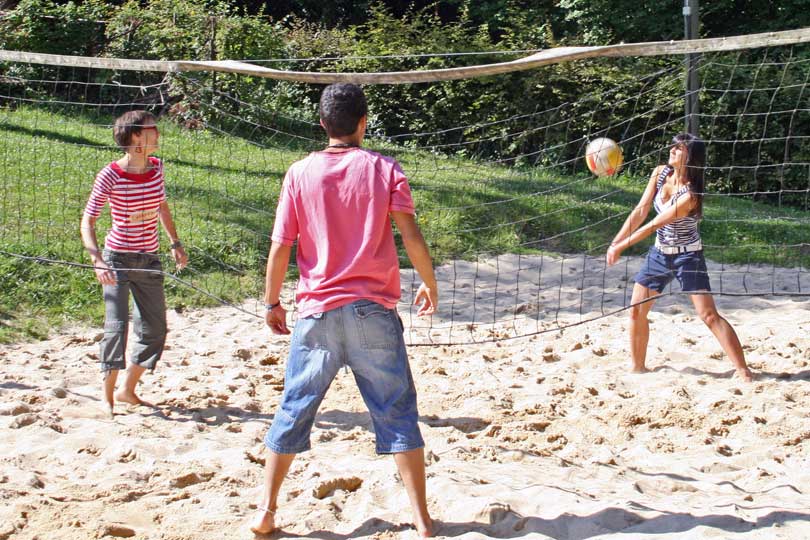 Offene Angebote: Campteilnehmer*innen beim Beachvolleyball